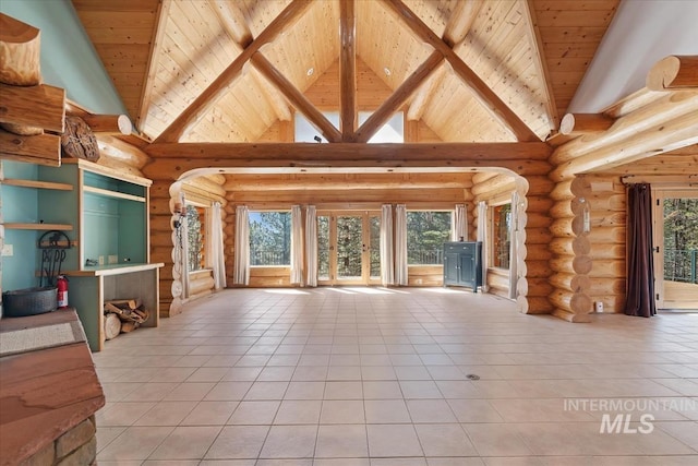 unfurnished living room with wood ceiling, light tile patterned floors, and a wealth of natural light