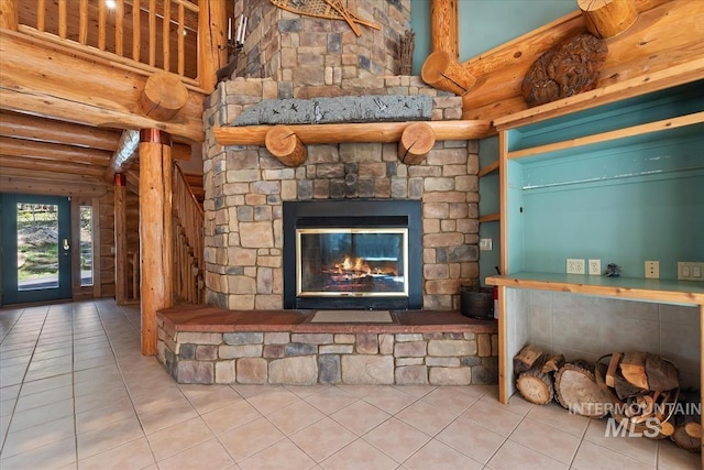 interior space featuring stairs, rustic walls, a fireplace, a high ceiling, and tile patterned floors