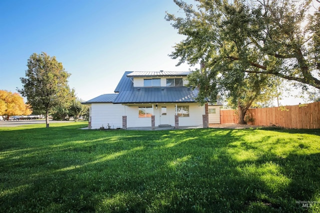 rear view of house with a lawn