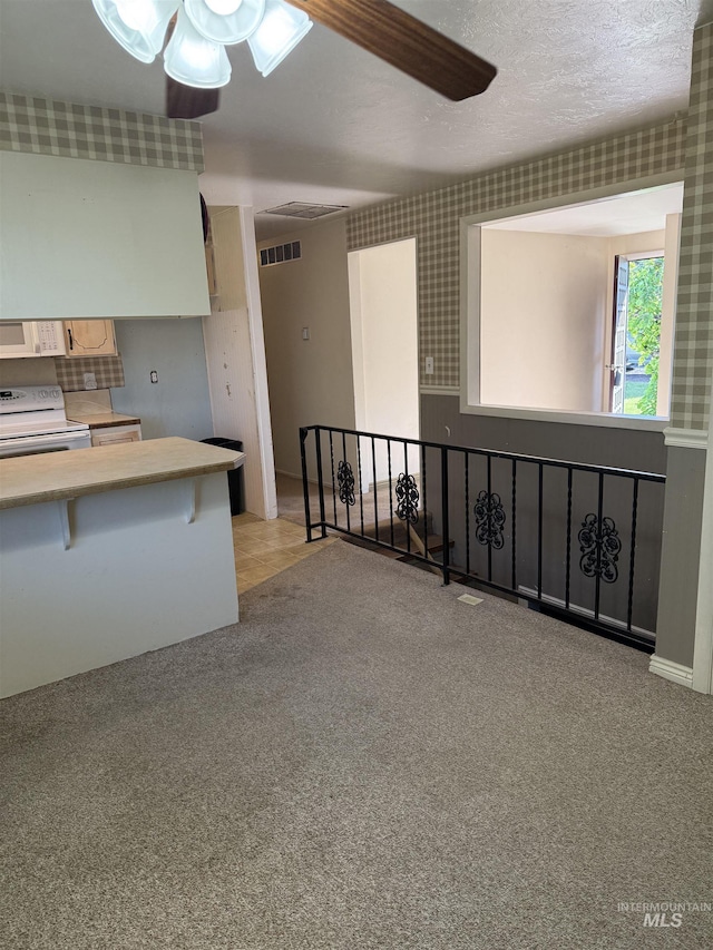 140 Quick Silver Ave, Hagerman, ID 83332 - kitchen with white electric range, a ceiling fan, and carpet flooring