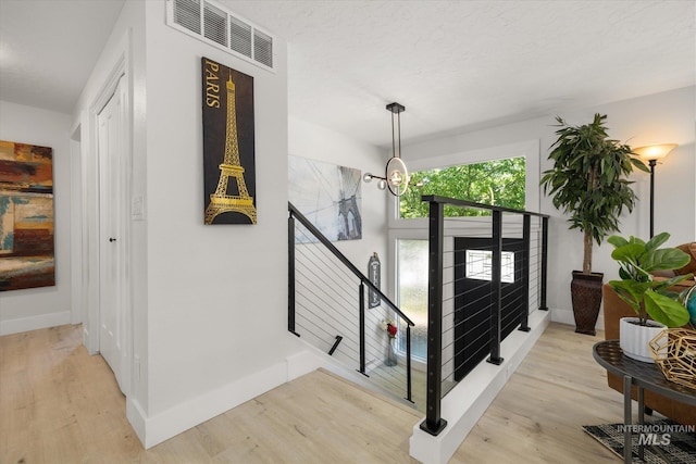 foyer entrance featuring baseboards and light wood-type flooring