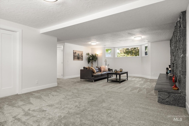 living room with a textured ceiling, carpet flooring, and baseboards
