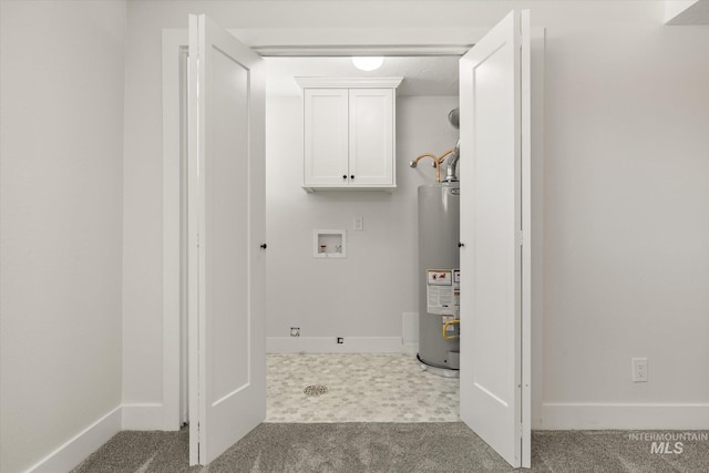 clothes washing area with gas water heater, carpet floors, washer hookup, cabinet space, and baseboards