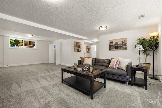 carpeted living room with baseboards and a textured ceiling