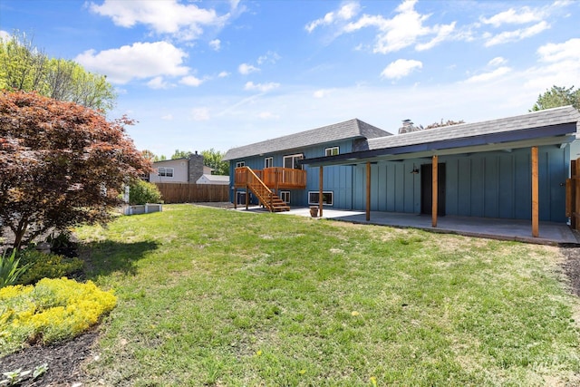 view of yard with a patio, stairway, and a wooden deck