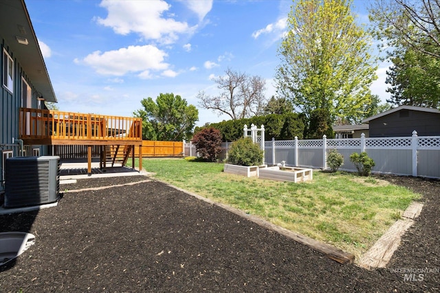 view of yard with cooling unit, a garden, and a deck