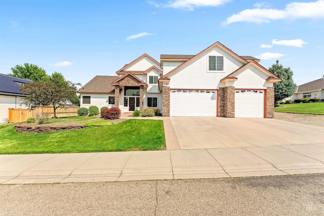 traditional-style house featuring a front lawn, concrete driveway, fence, and stucco siding