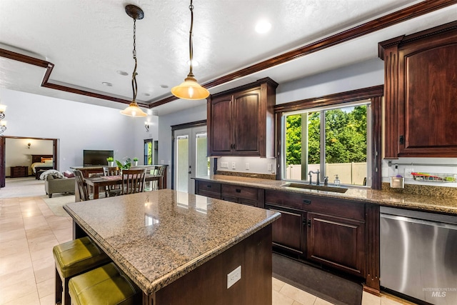 kitchen featuring a sink, dishwasher, a raised ceiling, decorative light fixtures, and a center island