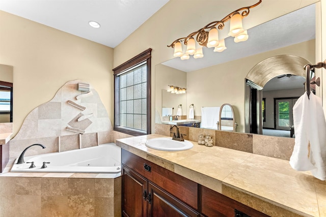 bathroom featuring vanity and a jetted tub