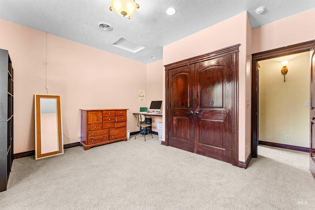 bedroom with baseboards, visible vents, light carpet, and attic access