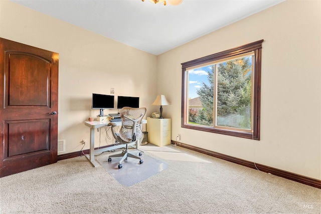 carpeted office space with visible vents and baseboards