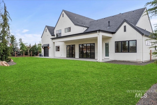 rear view of property featuring a yard