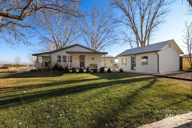 single story home with covered porch and a front yard