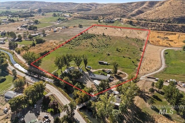 birds eye view of property featuring a mountain view and a rural view