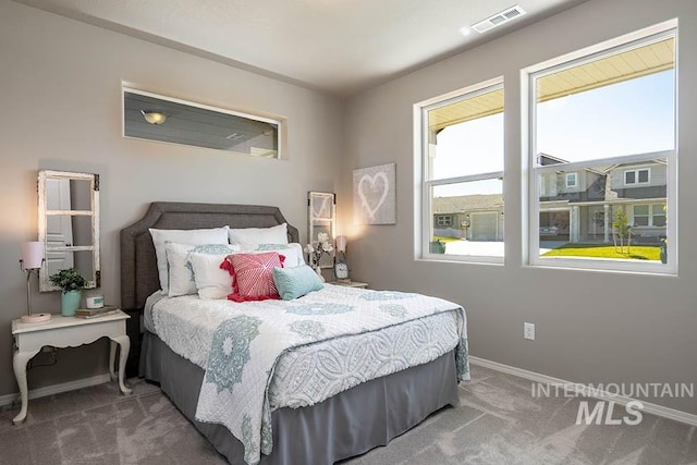 bedroom with carpet, visible vents, and baseboards