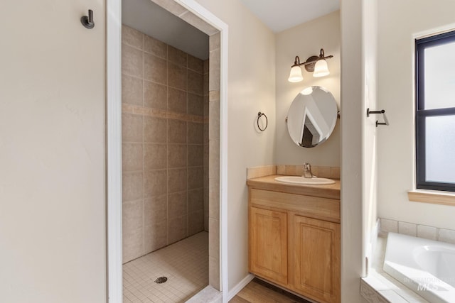 full bathroom with a tile shower, vanity, a bathtub, and a wealth of natural light