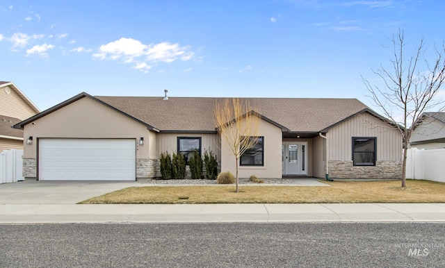 ranch-style home with a garage, driveway, stone siding, and fence