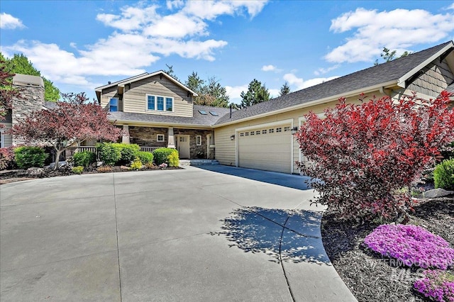 178 Cottonwood Ct, Eagle, ID 83616 - view of front of property featuring covered porch, driveway, an attached garage, and stone siding