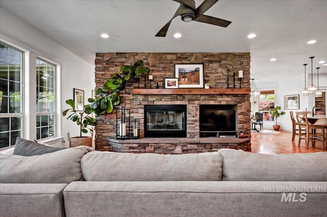 178 Cottonwood Ct, Eagle, ID 83616 - living area with wood finished floors, a ceiling fan, a stone fireplace, and recessed lighting