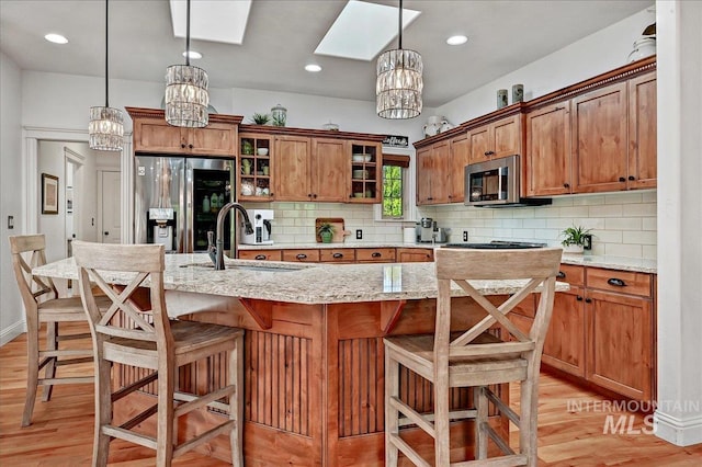178 Cottonwood Ct, Eagle, ID 83616 - kitchen with a skylight, stainless steel appliances, a chandelier, and a sink