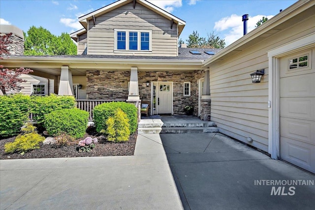 178 Cottonwood Ct, Eagle, ID 83616 - property entrance with stone siding, roof with shingles, and covered porch