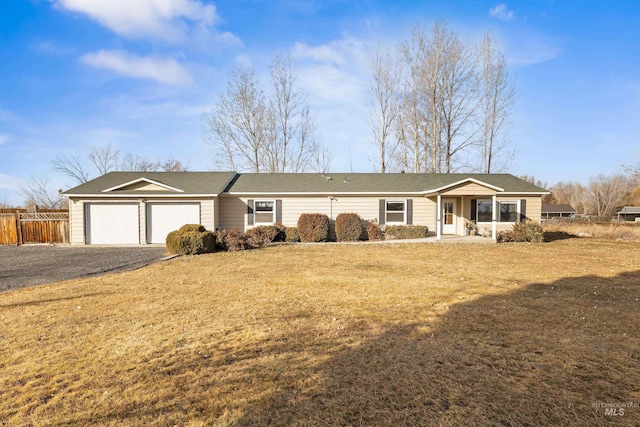 ranch-style house with a garage and a front lawn