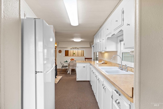 kitchen with white cabinetry, sink, and white appliances