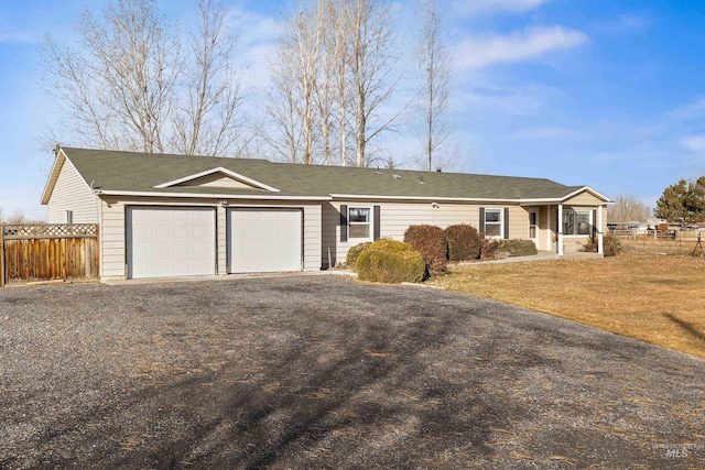 single story home with a garage and a front lawn