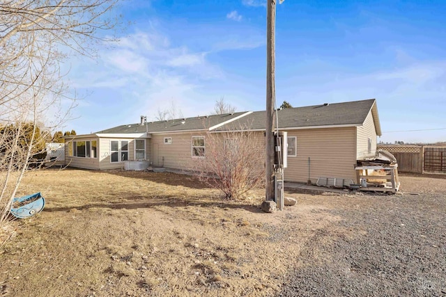 back of house with a lawn