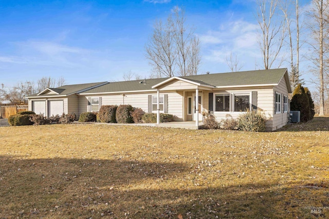 ranch-style home with a garage, a front yard, and central air condition unit