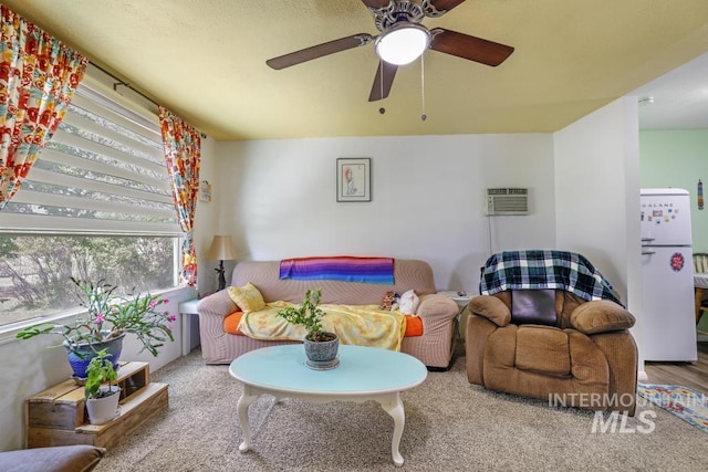 living area with plenty of natural light, ceiling fan, and a wall mounted AC