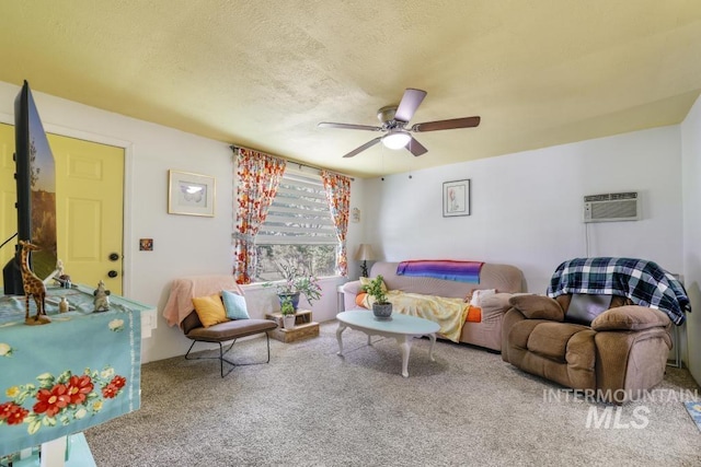 carpeted living area with an AC wall unit, a ceiling fan, and a textured ceiling