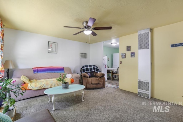 carpeted living room featuring a ceiling fan, a heating unit, and a textured ceiling