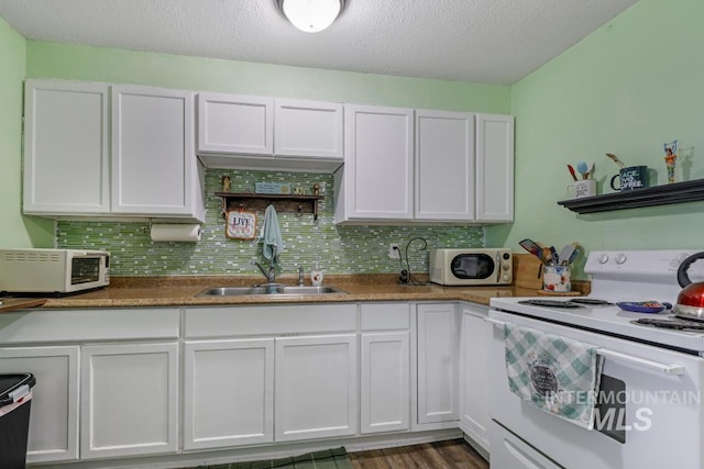 kitchen featuring a sink, white electric stove, decorative backsplash, and white cabinetry