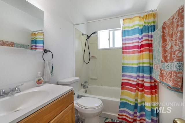 bathroom featuring vanity, shower / bath combo with shower curtain, and toilet