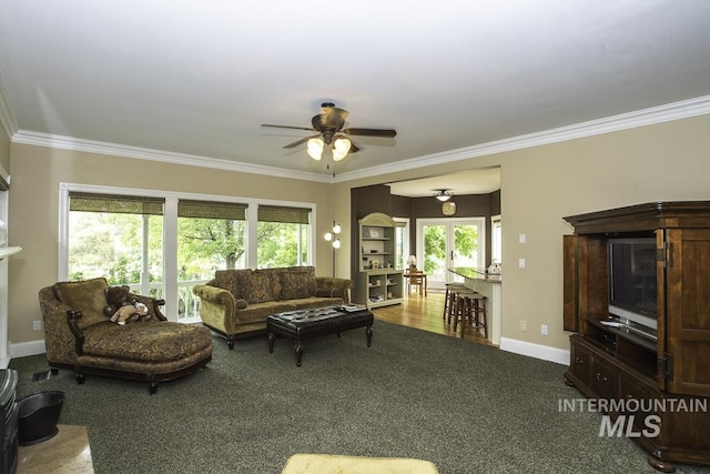 living area featuring ornamental molding, ceiling fan, and carpet floors
