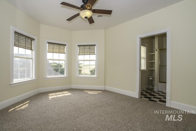 unfurnished bedroom featuring baseboards, a ceiling fan, and carpet floors