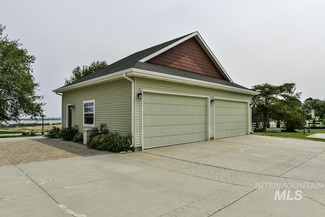 view of side of property with concrete driveway