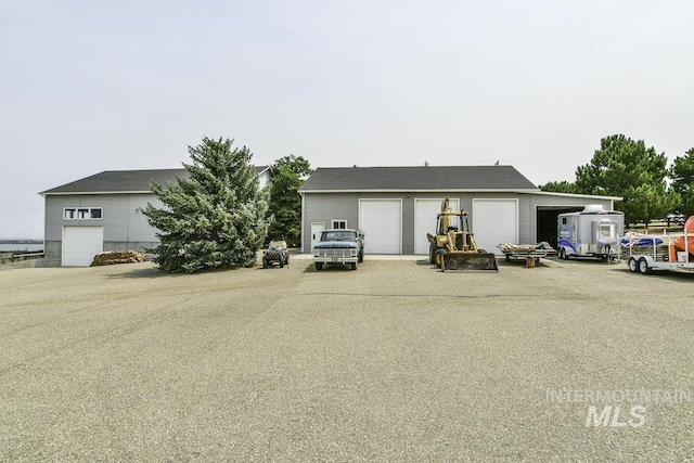 view of front of property featuring a garage and an outbuilding
