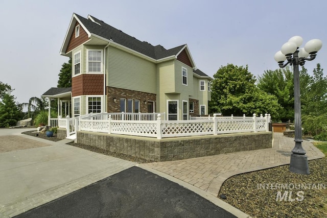 back of house with a deck and fence