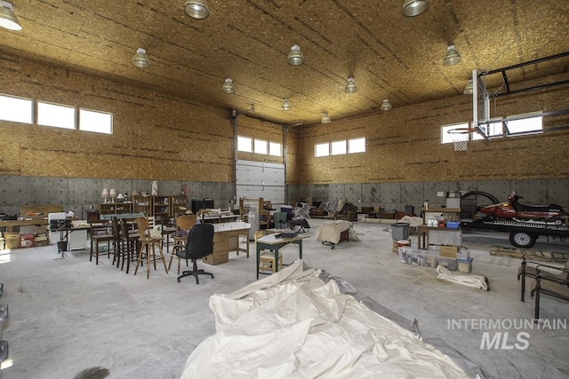 misc room featuring a garage and concrete flooring