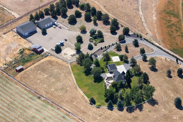 birds eye view of property with a rural view