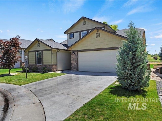 craftsman inspired home featuring a garage and a front lawn