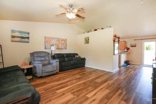 living room featuring lofted ceiling, hardwood / wood-style flooring, and ceiling fan