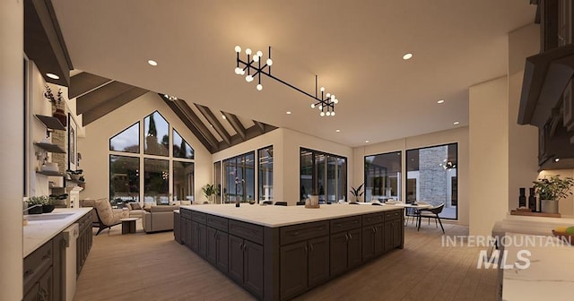 1976 W Oakhampton Dr, Eagle, ID 83616 - kitchen with a chandelier, light countertops, open floor plan, a center island, and light wood-style floors