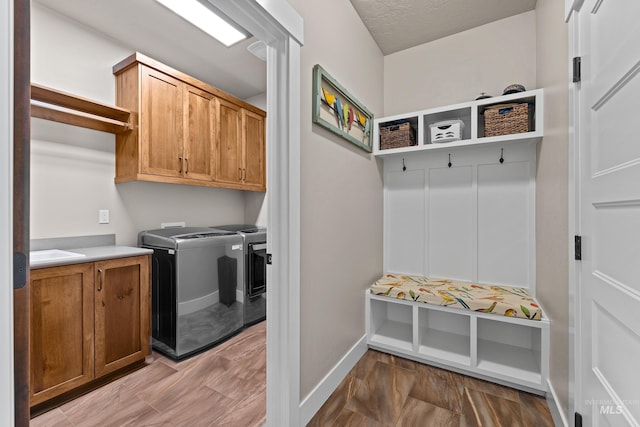 interior space with light wood-type flooring, separate washer and dryer, and sink