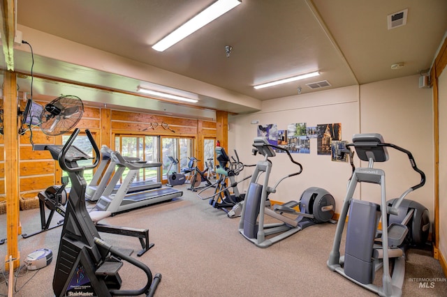 gym with wood walls and carpet