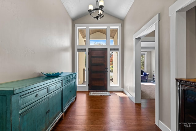 entryway featuring wine cooler, dark wood-type flooring, a chandelier, and vaulted ceiling