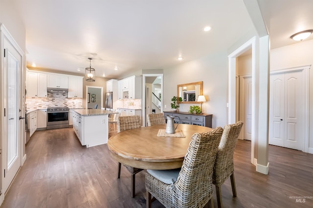 dining space featuring baseboards, dark wood finished floors, and recessed lighting