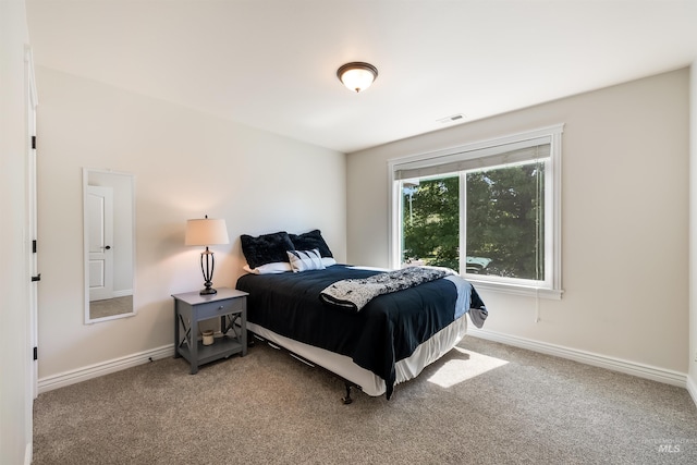 carpeted bedroom with visible vents and baseboards